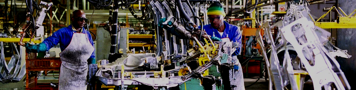 man cleaning on floor beside white wall