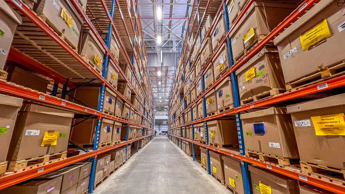 A man in a suit walking outside a modern office building.
