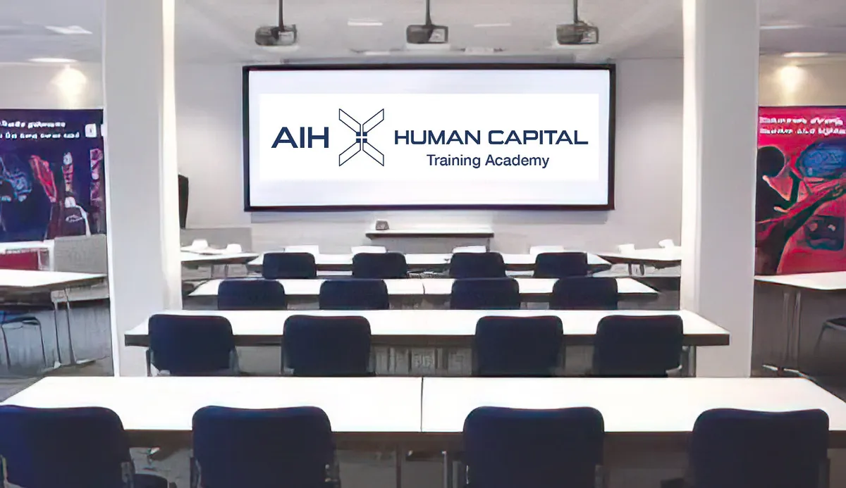 A smiling man in a suit with his arms crossed, standing outdoors.